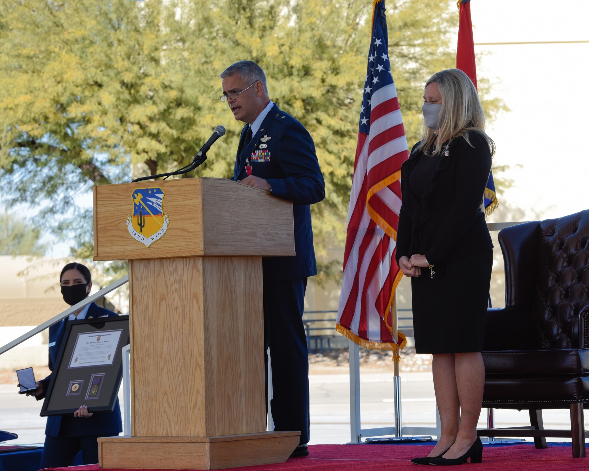 Brig. Gen. Andrew MacDonald, the former commander of the 162nd Wing, honored his wife's service with a medal and plaque during his retirement ceremony Jan. 10 at the Morris Air National Guard Base. Due to the COVID-19 pandemic, the wing held a ceremony for MacDonald’s retirement by limiting attendance to family and distinguished guests, in person, while live-streaming the event to members across base. (U.S. Air National Guard Photo by Staff Sgt. Aubrey Pomares/Released)