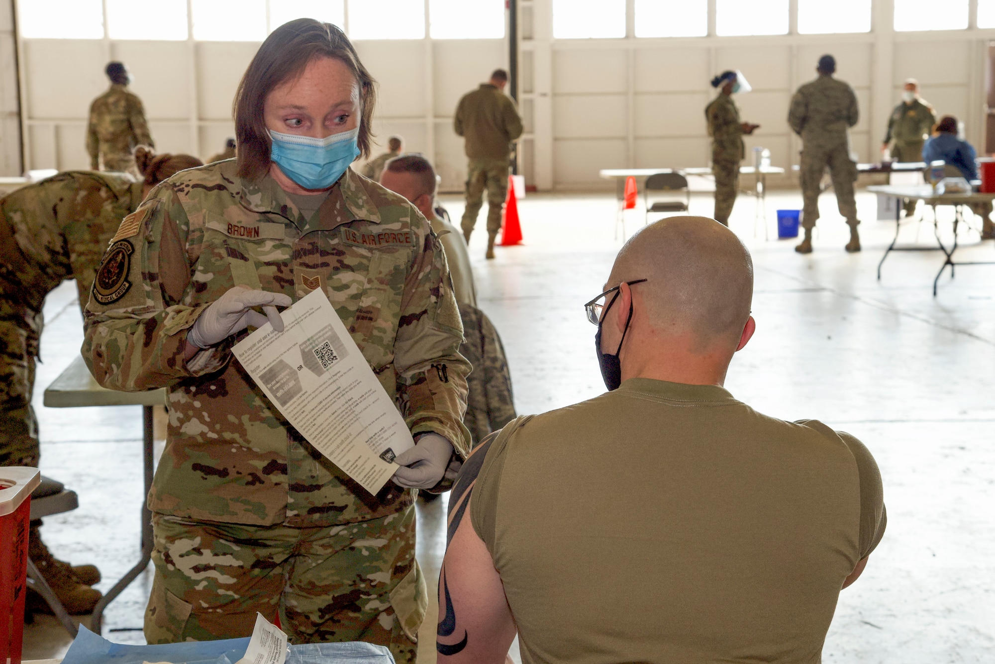 Tech. Sgt. Barbara Brown, 108th Wing Medical Group, displays a factsheet after administering the COVID-19 vaccine at Joint Base McGuire-Dix-Lakehurst, N.J., Jan. 9, 2021. This was the first time the 108th Wing administered the COVID-19 vaccines to wing members.