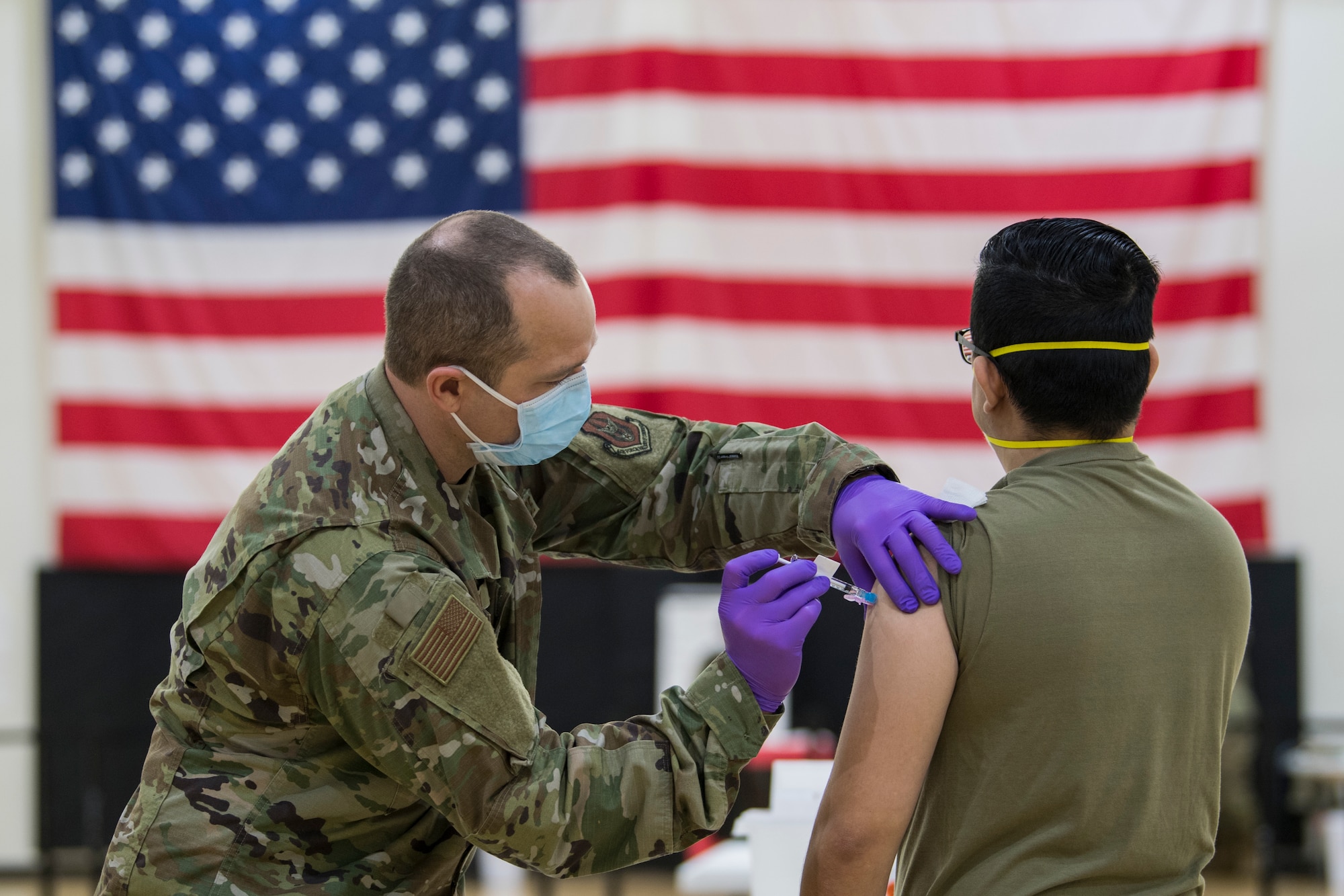 U.S. Air Force 2nd Lt. James Black, a clinical nurse with the 514th Aerospace Medicine Squadron, 514th Air Mobility Wing, administers a COVID-19 vaccine to Tech Sgt. David Bettetta, and optometry specialist with the 514 AMDS at Joint Base McGuire-Dix-Lakehurst, N.J., on Jan. 9, 2021.