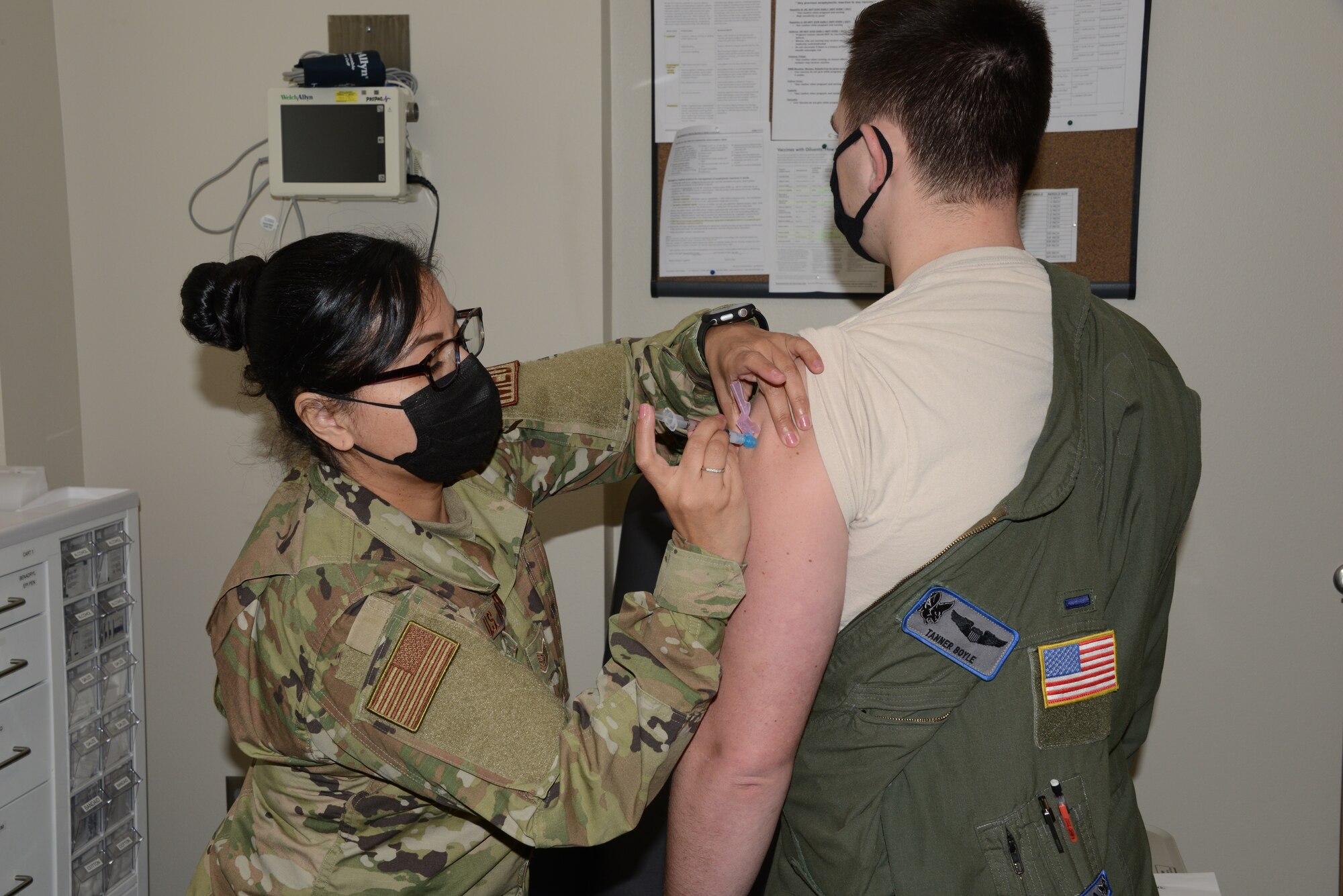 Technical Sgt. Perla Solis, 185th Air Refueling Wing medical technician, administers the first of two COVID-19 vaccines to an Airman from the Iowa Air National Guard at the Sioux City, Iowa, clinic on Jan. 9, 2021.