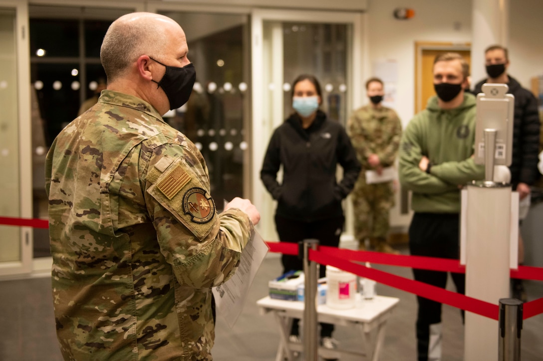 U.S. Air Force Maj. Richard Gray, left, 501st Combat Support Wing chief of medical staff, informs 423rd Security Forces Squadron Airmen about the COVID-19 vaccine prior to its administration at Royal Air Force Alconbury, England, Jan. 5, 2021. 501st CSW first responders were prioritized to receive the vaccine based on the guidance from the Centers for Disease Control and Prevention as well as the DoD COVID Task Force’s assessment of unique DoD mission requirements. (U.S. Air Force photo by Senior Airman Jennifer Zima)