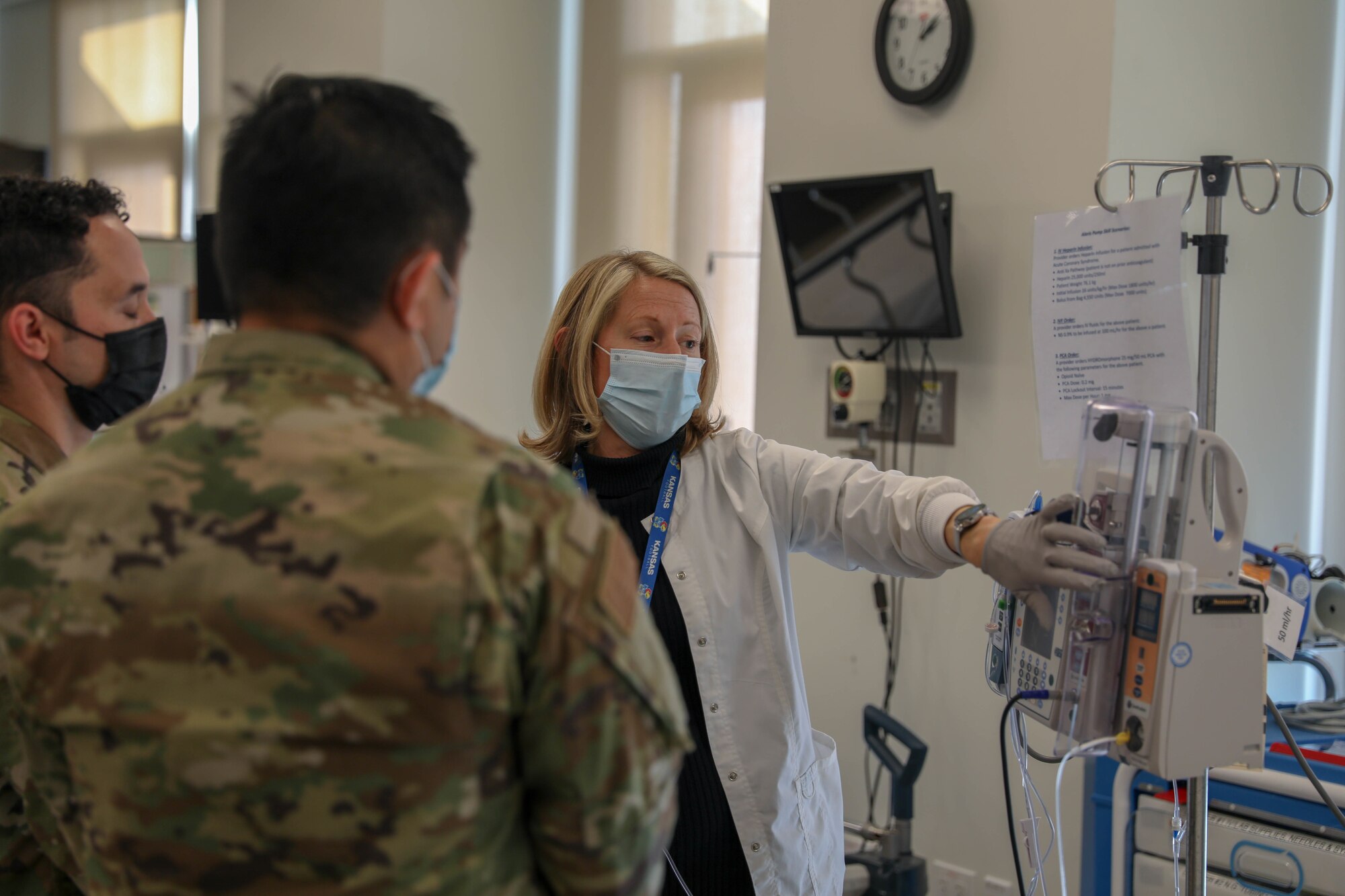Image of a doctor talking to Airmen.