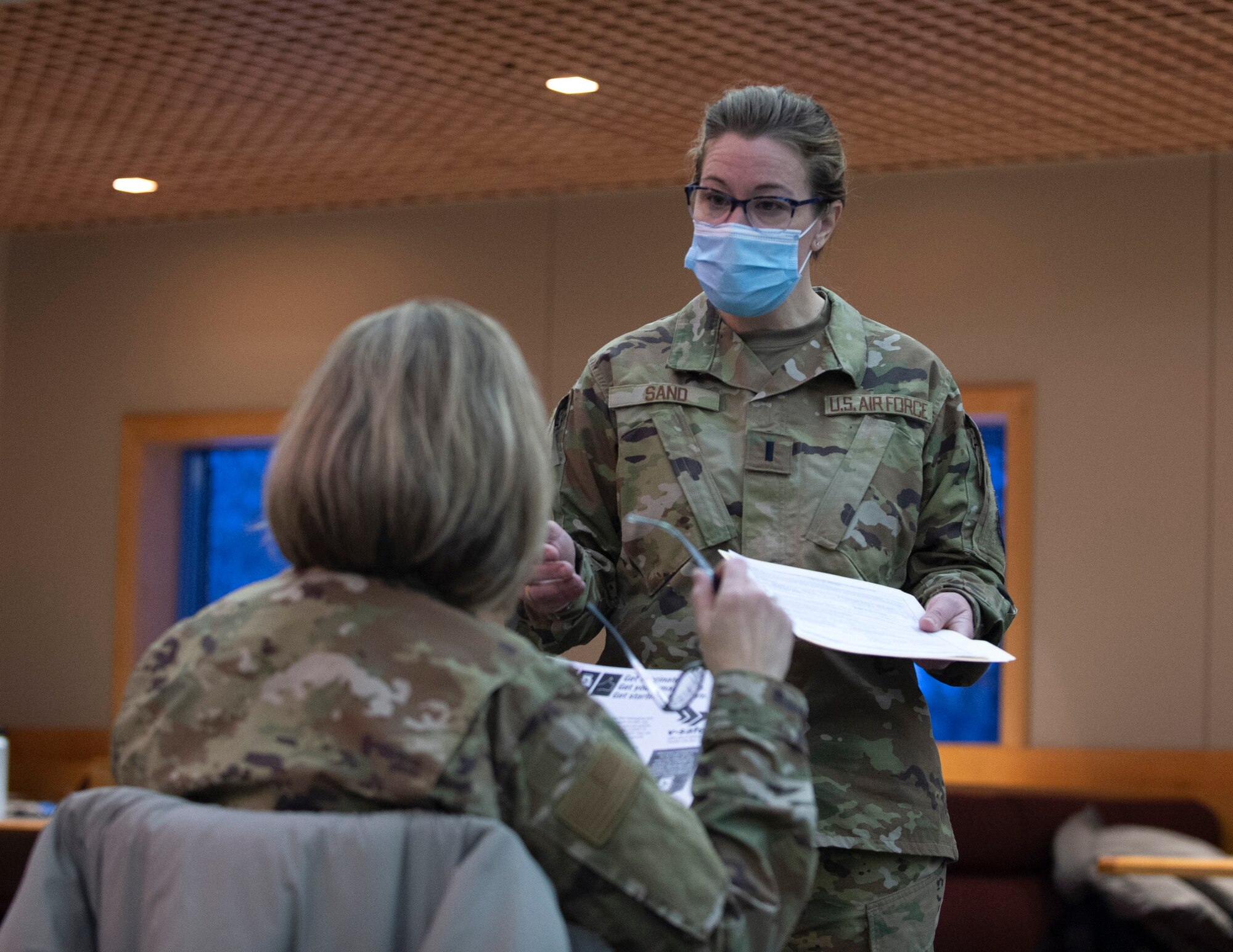 U.S. Air Force 1st Lt. Merci Sand, 133rd Medical Group, talks to Airmen while they wait after receiving the COVID-19 vaccine in St. Paul, Minn., Jan. 8, 2021.