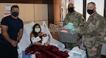 Brig. Gen. Shan Bagby, commander, Brooke Army Medical Center, and Command Sgt. Maj. Thurman Reynolds congratulate U.S. Air Force Staff Sgt. Jessica Ojeda-Nolasco, a C5 aviation research manager at Lackland Air Force Base, husband Isaac Nolasco, and their daughter Stella Luna, Jan 2, 2021. Stella Luna was the first baby born at BAMC, Jan. 1, 2021, at 3:26 a.m., weighing 8 pounds, and 2 ounces.