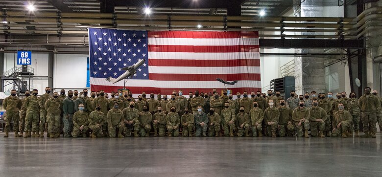 Chief Master Sgt. of the Air Force JoAnne S. Bass, along with members of the 436th and 512th Maintenance Group pose for a group photo after a MXG all-call Jan. 8, 2021, at Dover Air Force Base, Delaware. Bass spoke to approximately 75 junior Airmen and answered questions they had. This marked Bass’ first official visit to Dover AFB since she assumed her position as the 19th chief master sergeant of the Air Force on Aug. 14, 2020. (U.S. Air Force photo by Roland Balik)
