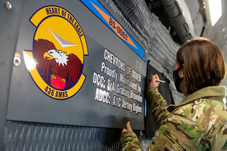 Chief Master Sgt. of the Air Force JoAnne S. Bass signs a plaque during a C-5M Super Galaxy static display walk-through Jan. 8, 2021, on Dover Air Force Base, Delaware. The office of the Chief Master Sergeant of the Air Force represents the highest enlisted level of leadership, provides direction for the enlisted corps and represents their interests to the American public and all levels of government. Dover is home to nearly 11,000 total force Airmen supporting 20% of the nation’s strategic airlift capability.(U.S. Air Force photo by Senior Airman Christopher Quail)