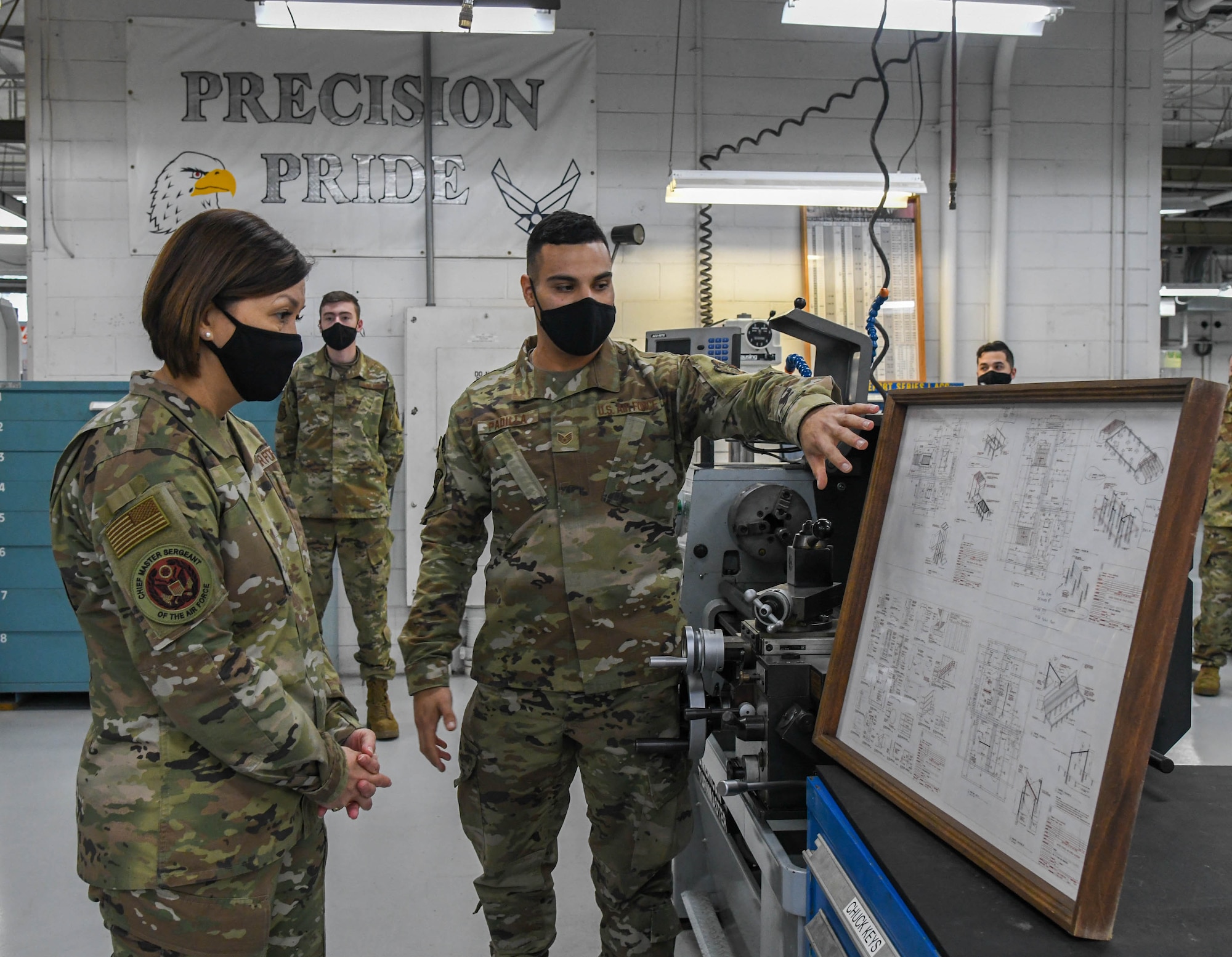 Staff Sgt. Christian Padilla, 436th Maintenance Squadron metals technician apprentice, explains a conex schematic to Chief Master Sergeant of the Air Force JoAnne S. Bass during her visit to Dover Air Force Base, Delaware, Jan. 8, 2021. Bass witnessed firsthand how Dover AFB supports Air Force priorities such as enhancing full-spectrum readiness and developing innovative, multi-capable Airmen. (U.S. Air Force photo by Airman 1st Class Stephani Barge)