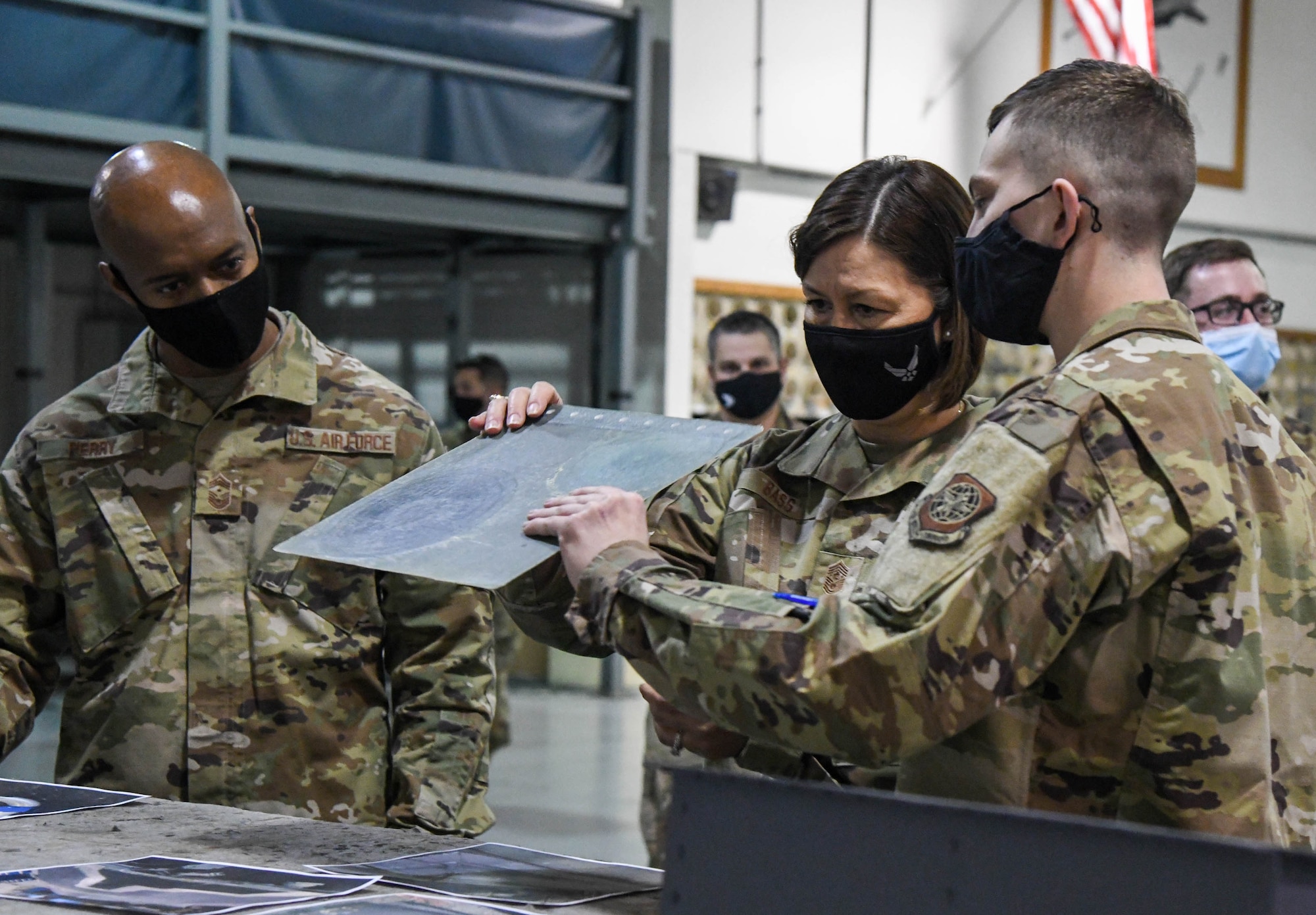 Senior Airman Donovan Lamore, 436th Maintenance Squadron aircraft structural maintenance apprentice, shows a metal sheet to Chief Master Sergeant of the Air Force JoAnne S. Bass, during her visit to Dover Air Force Base, Delaware, Jan. 8, 2021. Chief Bass witnessed firsthand how Dover AFB supports Air Force priorities such as enhancing full-spectrum readiness and developing innovative, multi-capable Airmen. (U.S. Air Force photo by Airman 1st Class Stephani Barge)