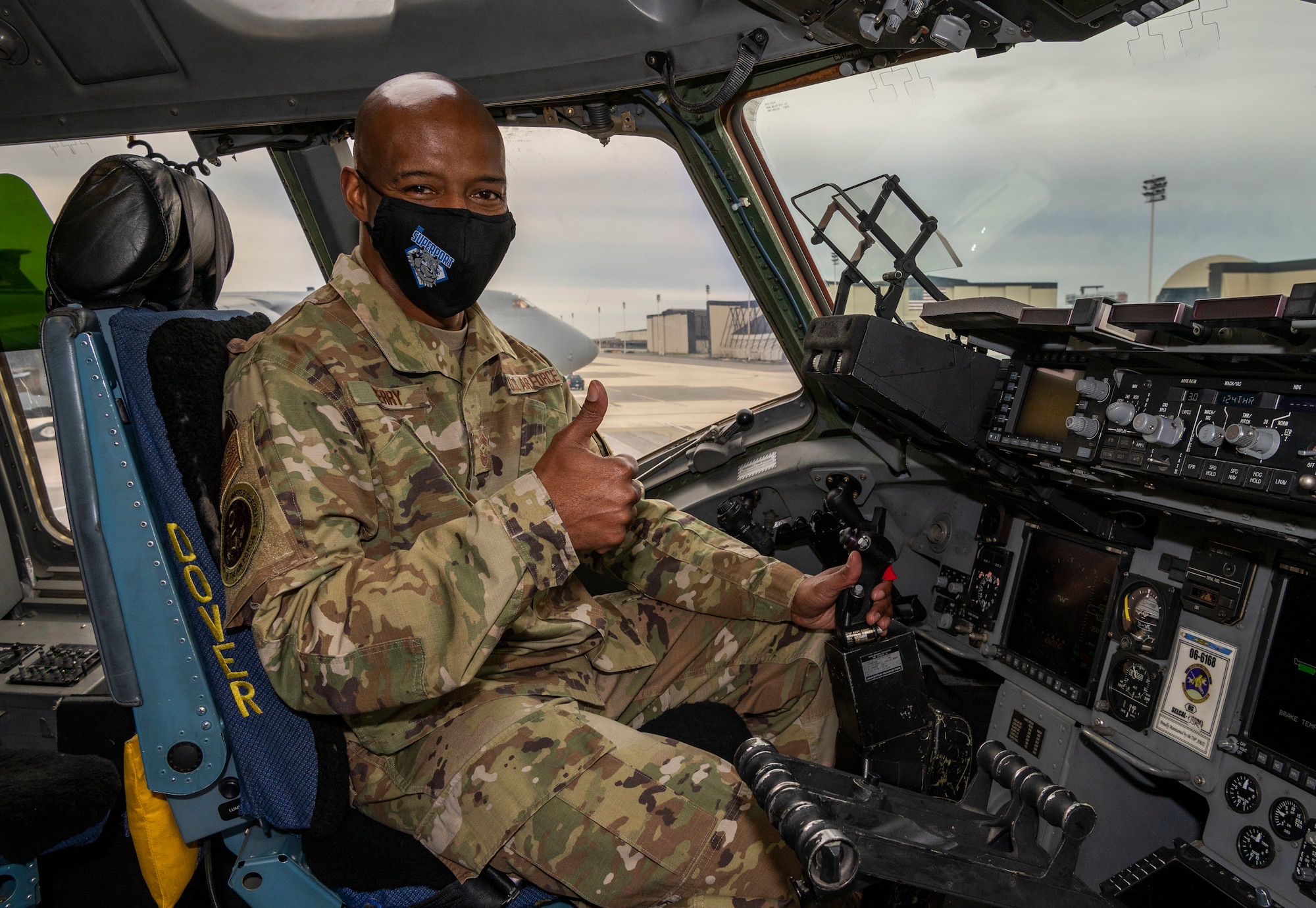 Chief Master Sgt. Mike Perry, Air Force First Sergeant special duty manager, poses for a photo in the pilot seat of a C-17 Globemaster III during a static display walk-through Jan. 8, 2021, on Dover Air Force Base, Delaware. During his visit, Perry witnessed firsthand how Dover AFB projects the Joint Force and supports 20% of the nation's strategic airlift. (U.S. Air Force photo by Senior Airman Christopher Quail)