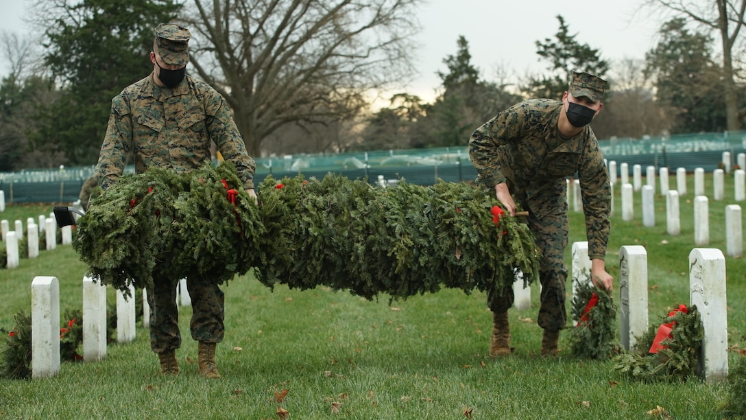 U.S. Marines join soldiers, sailors and airmen in picking up and disposing of wreaths at Arlington National Cemetery, Va., Jan. 8.