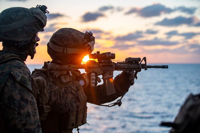 A U.S. Marine fires his M4 carbine during a combat marksmanship training event aboard the amphibious assault ship USS Makin Island (LHD 8), Dec. 19.