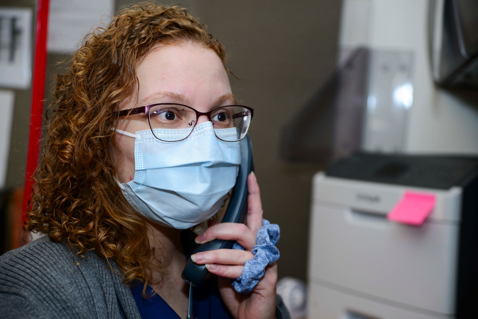 Jenna Stacey-Marshall, Naval Medical Center Portsmouth (NMCP) pharmacy technician, works with a patient in NMCP’s Pharmacy Call Center, Jan. 8.