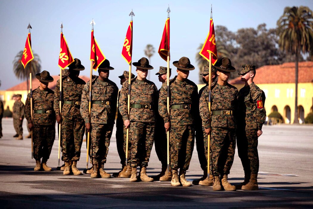 Drill instructors with Charlie Company, 1st Recruit Training Battalion, exchange guidons during a graduation ceremony at Marine Corps Recruit Depot, San Diego, Jan. 8, 2021.