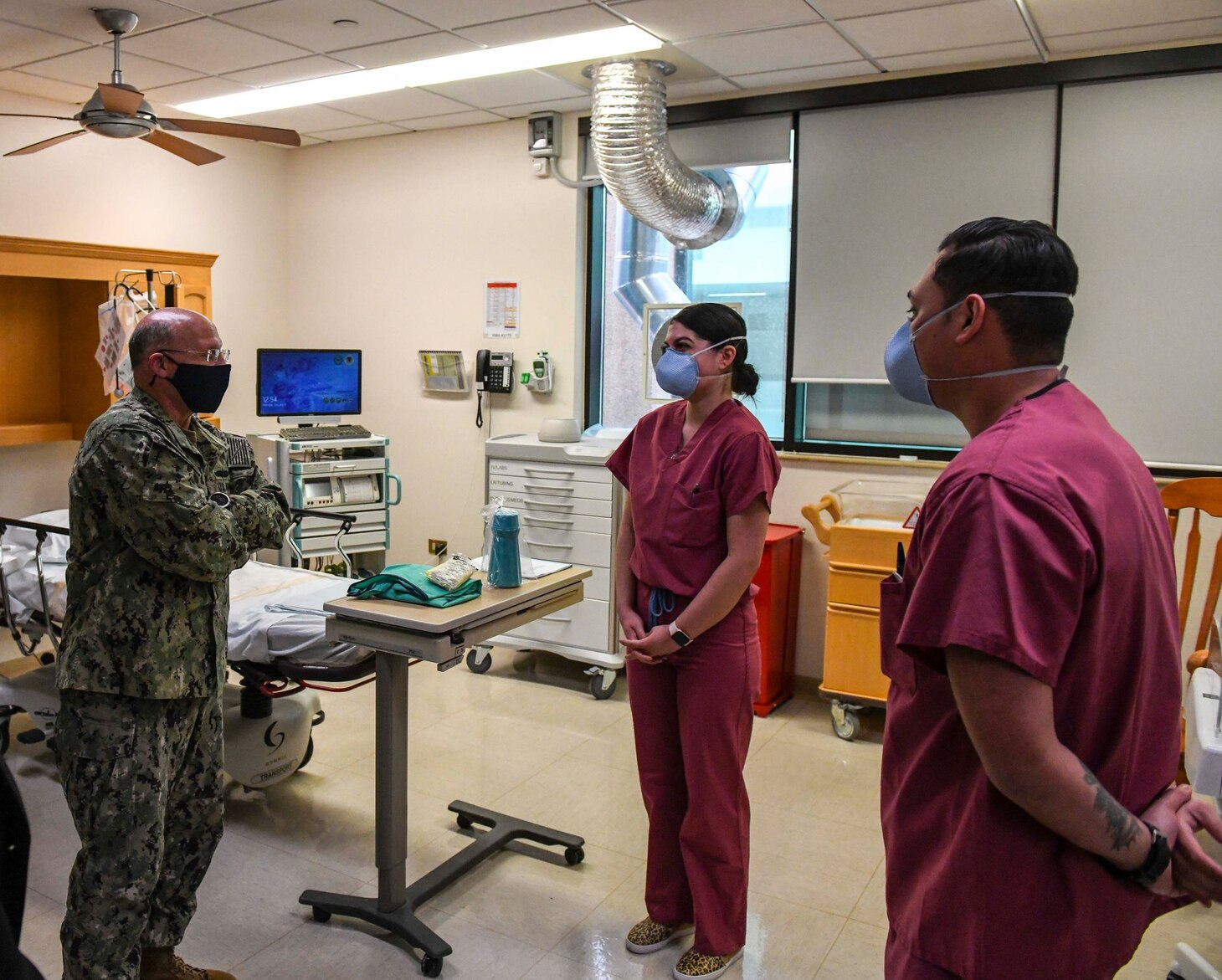 Adm. Mike Gilday, Chief of Naval Operations, left, speaks with Corpsmen assigned to the Multi Service Ward at U.S. Naval Hospital Naples, Italy, about negative-pressure rooms used to treat potential coronavirus (COVID-19) patients at the hospital, Jan. 11, 2021. USNH Naples, the largest naval hospital in Europe, serves a diverse population of over 9,800 beneficiaries. Over 500 staff members at the main hospital, branch health clinic, and Navy Liaison Detachment in Landstuhl, Germany work tirelessly to keep warfighters in the fight and provide care for their families. (U.S. Navy photo by Mass Communication Specialist 3rd Class Trey Fowler/ Released)