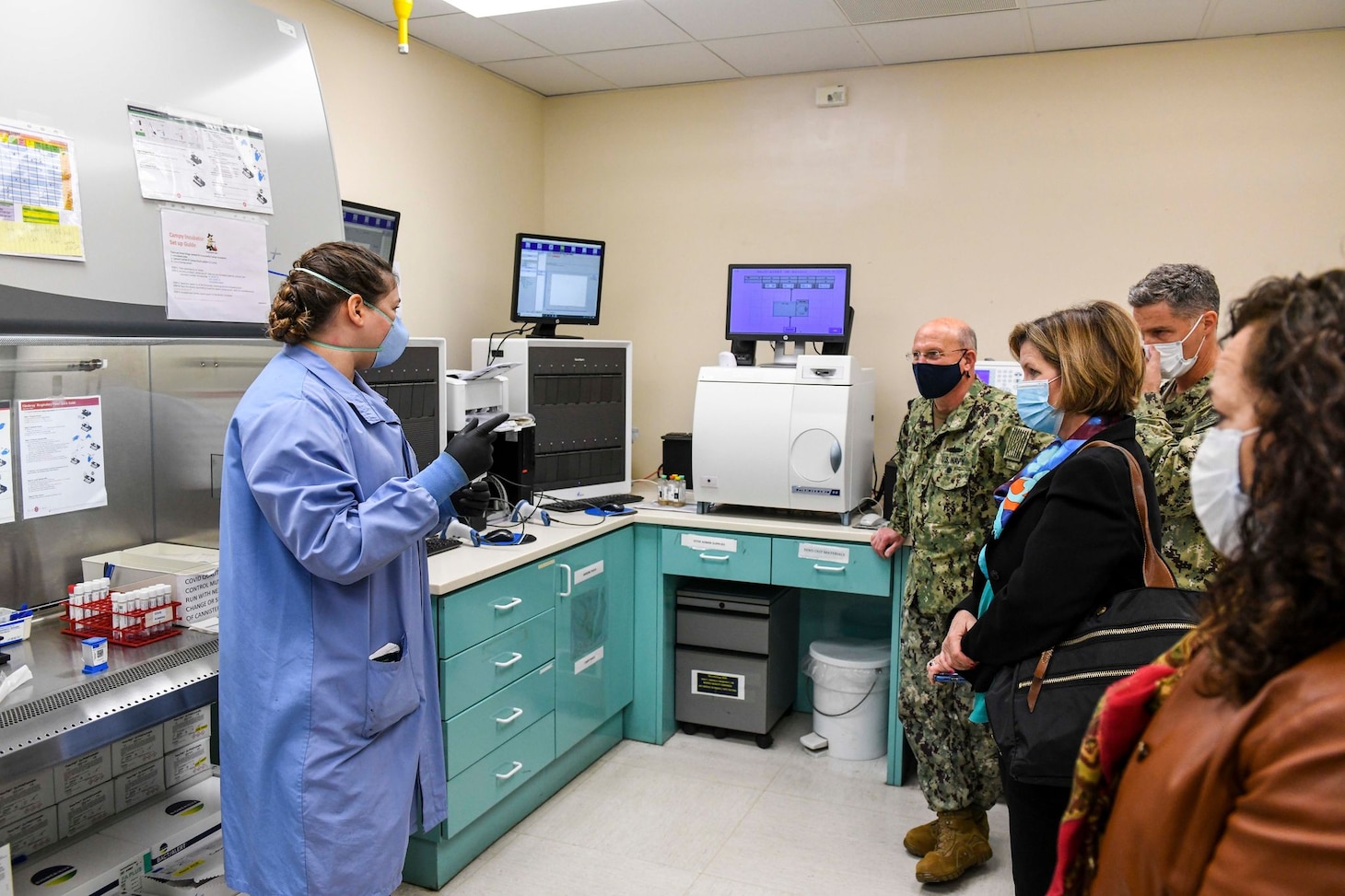 NAVAL SUPPORT ACTIVITY NAPLES, Italy (Jan. 11, 2021) Chief of Naval Operations Adm. Mike Gilday, center, and his wife, Mrs. Linda Gilday, right center, observe as Hospital Corpsman 2nd Class Allison Jones, assigned to the laboratory staff at U.S. Naval Hospital Naples, Italy, demonstrates how a COVID-19 polymerase chain reaction (PCR) test is processed at the hospital’s laboratory at Naval Support Activity Naples, Italy, Jan. 11, 2021. USNH Naples, the largest naval hospital in Europe, serves a diverse population of over 9,800 beneficiaries. Over 500 staff members at the main hospital, branch health clinic, and Navy Liaison Detachment in Landstuhl, Germany work tirelessly to keep warfighters in the fight and provide care for their families. (U.S. Navy photo by Mass Communication Specialist 3rd Class Trey Fowler/ Released)