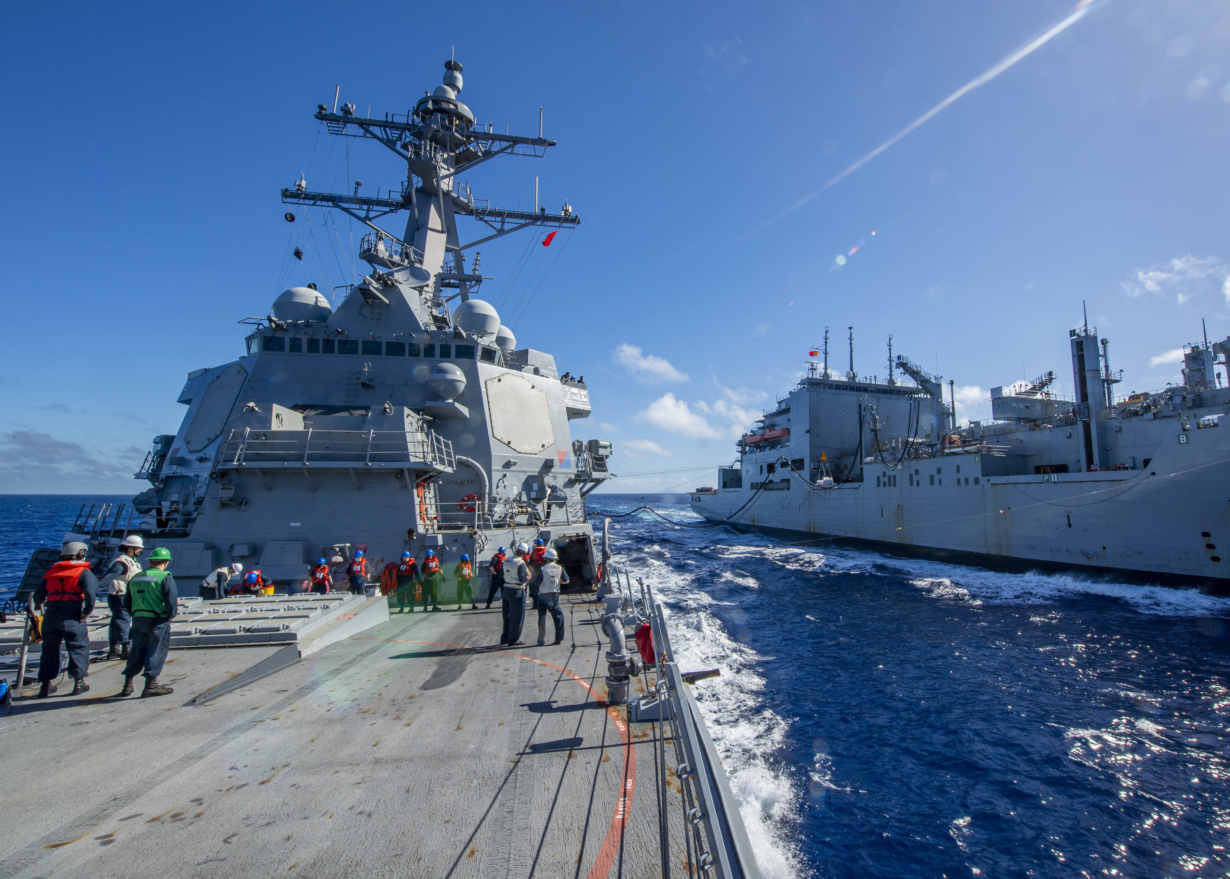 The Military Sealift Command dry cargo and ammunition ship USNS Charles Drew (T-AKE 10), right, sends fuel to the Arleigh Burke-class guided-missile destroyer USS John Finn (DDG 113) during a replenishment-at-sea Jan. 8, 2021.