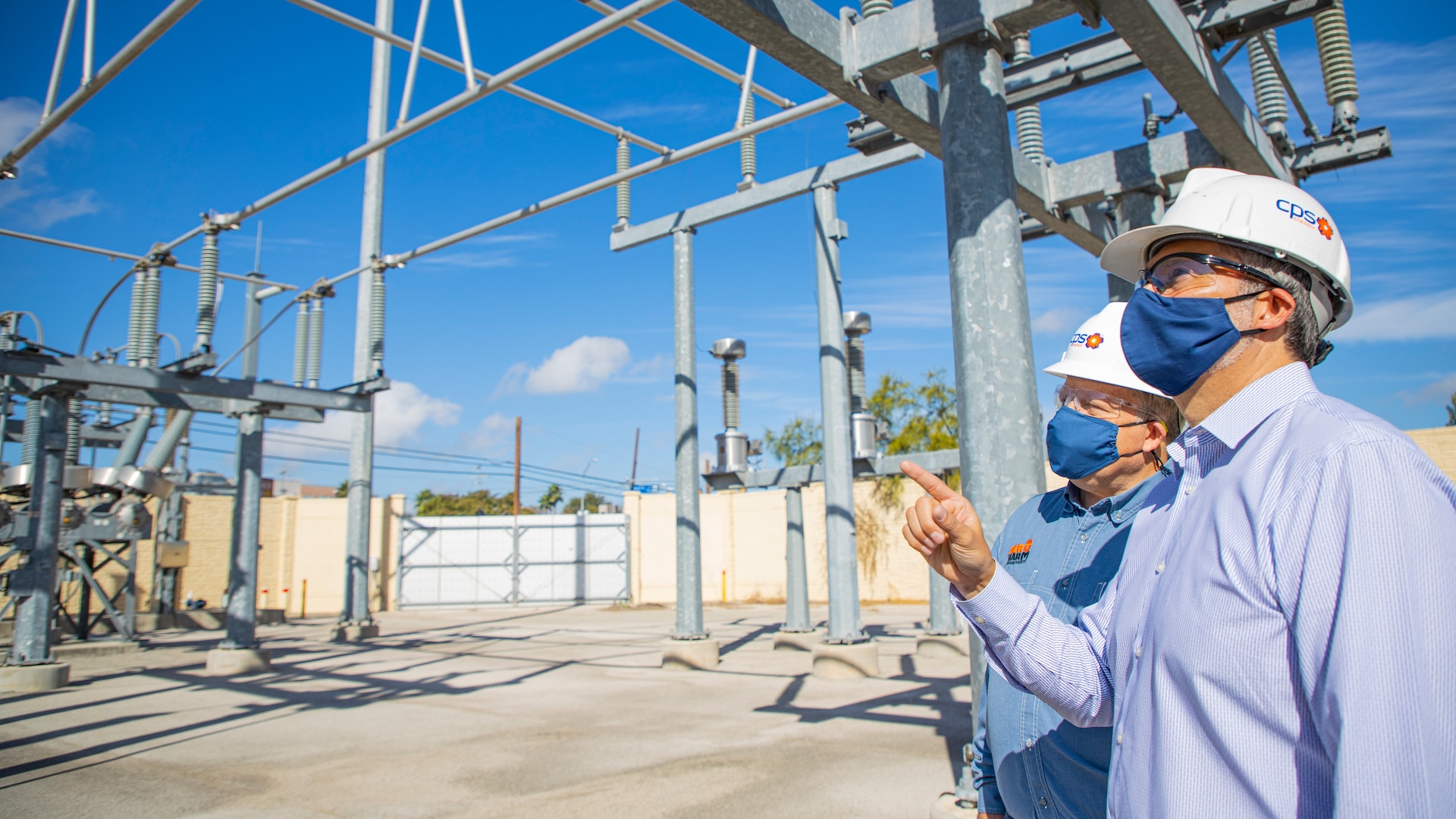 CPS Energy’s Vice President of Grid Transformation & Engineering, Richard Medina, front, and Chief Security, Safety & Gas Solutions Officer Fred Bonewell evaluate security measures at an area substation.