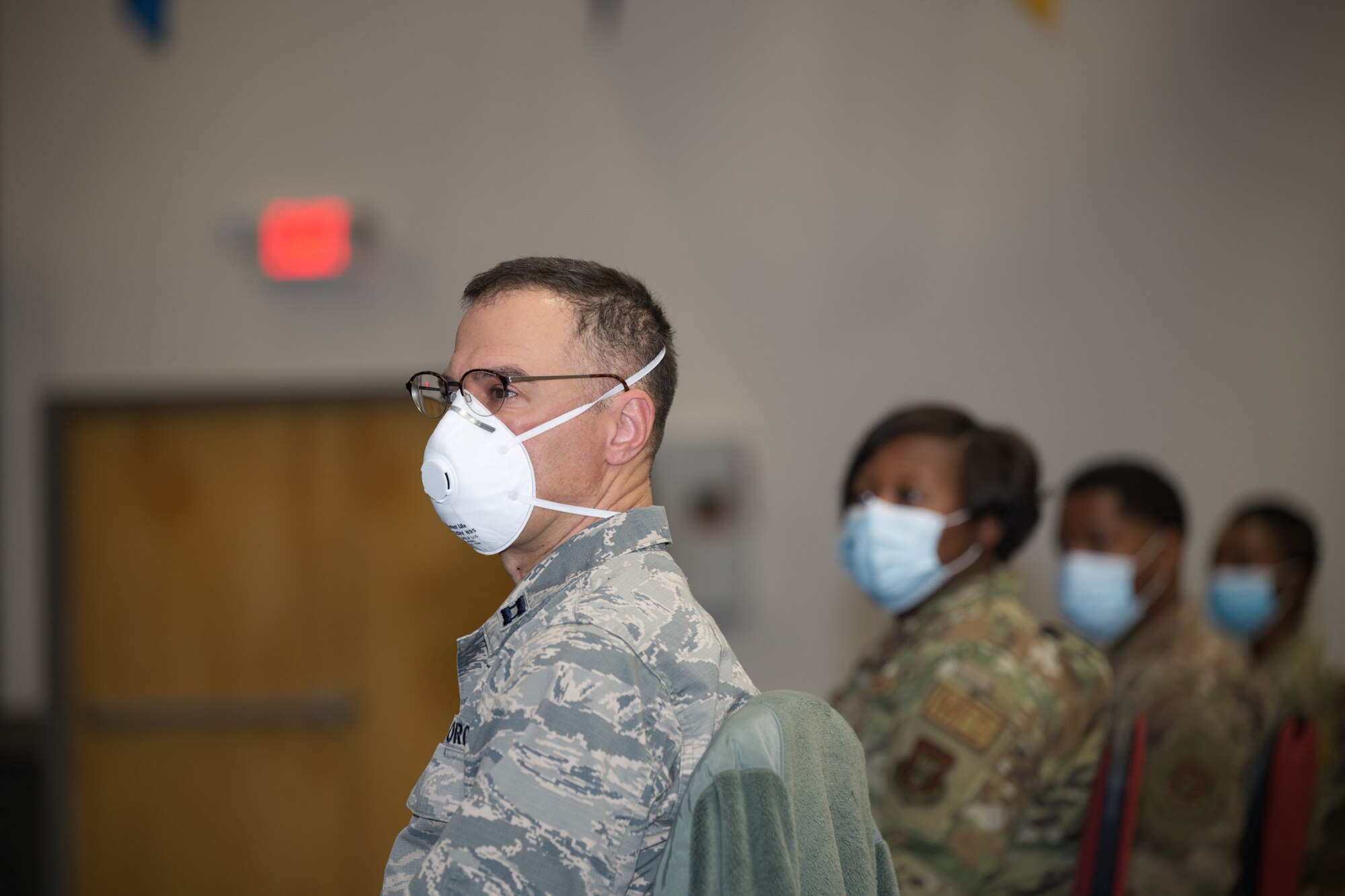 Photo of Airman with mask looking to his left