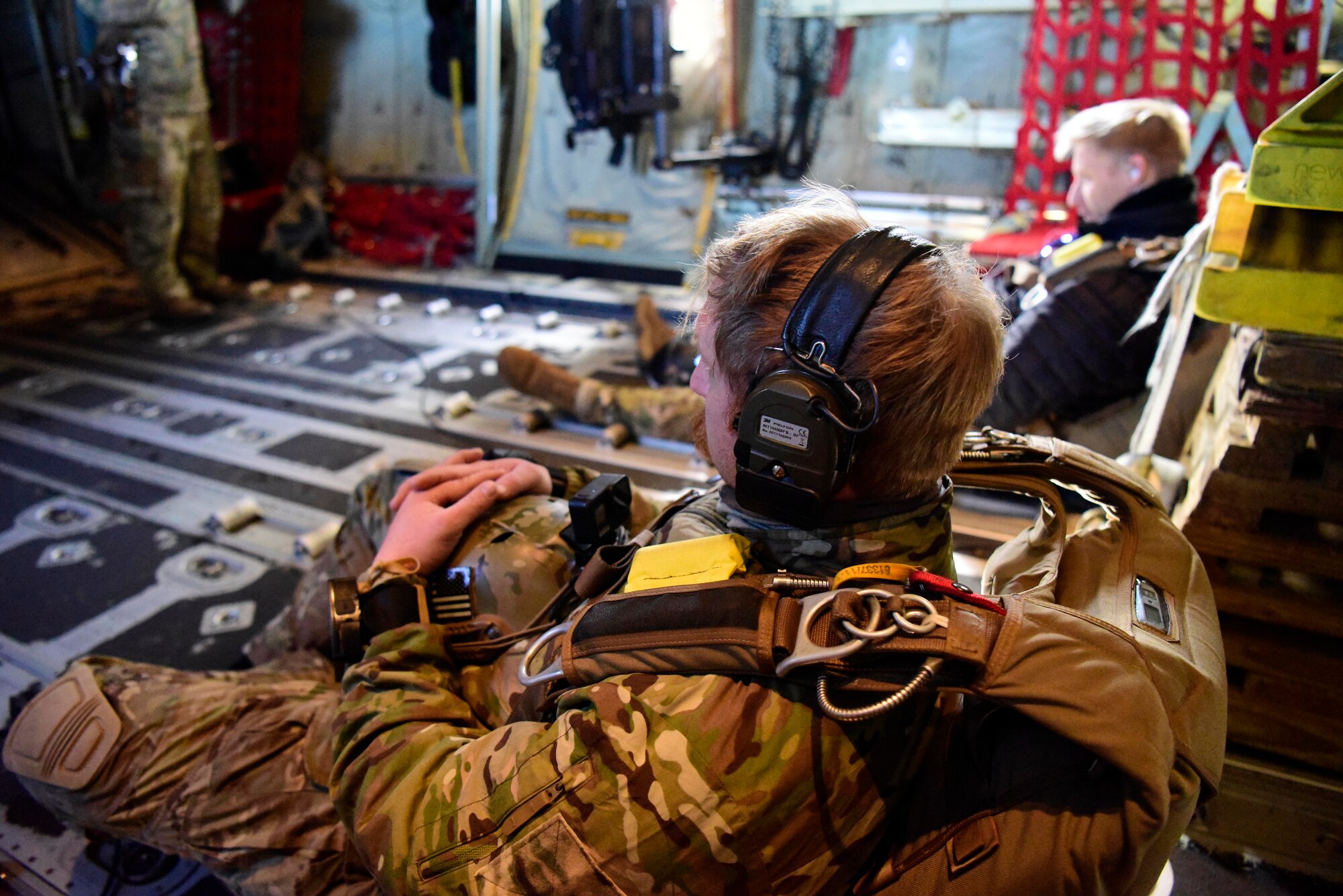 Airman and Soldier seated in C-130J Super Hercules