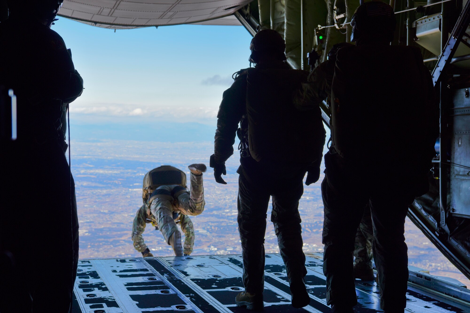 Airman and Soldiers jumping out of C-130J Super Hercules