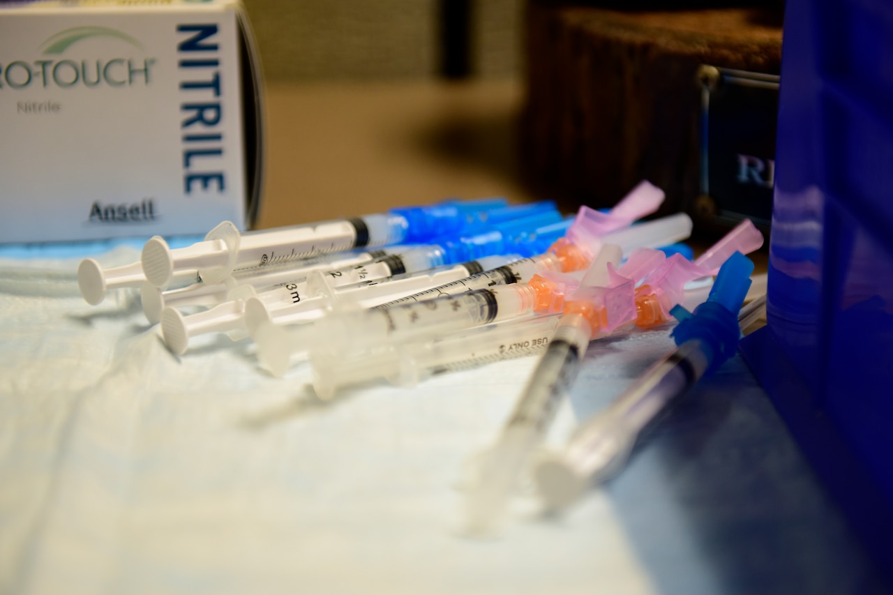 Syringes filled with COVID-19 vaccines are on a table.