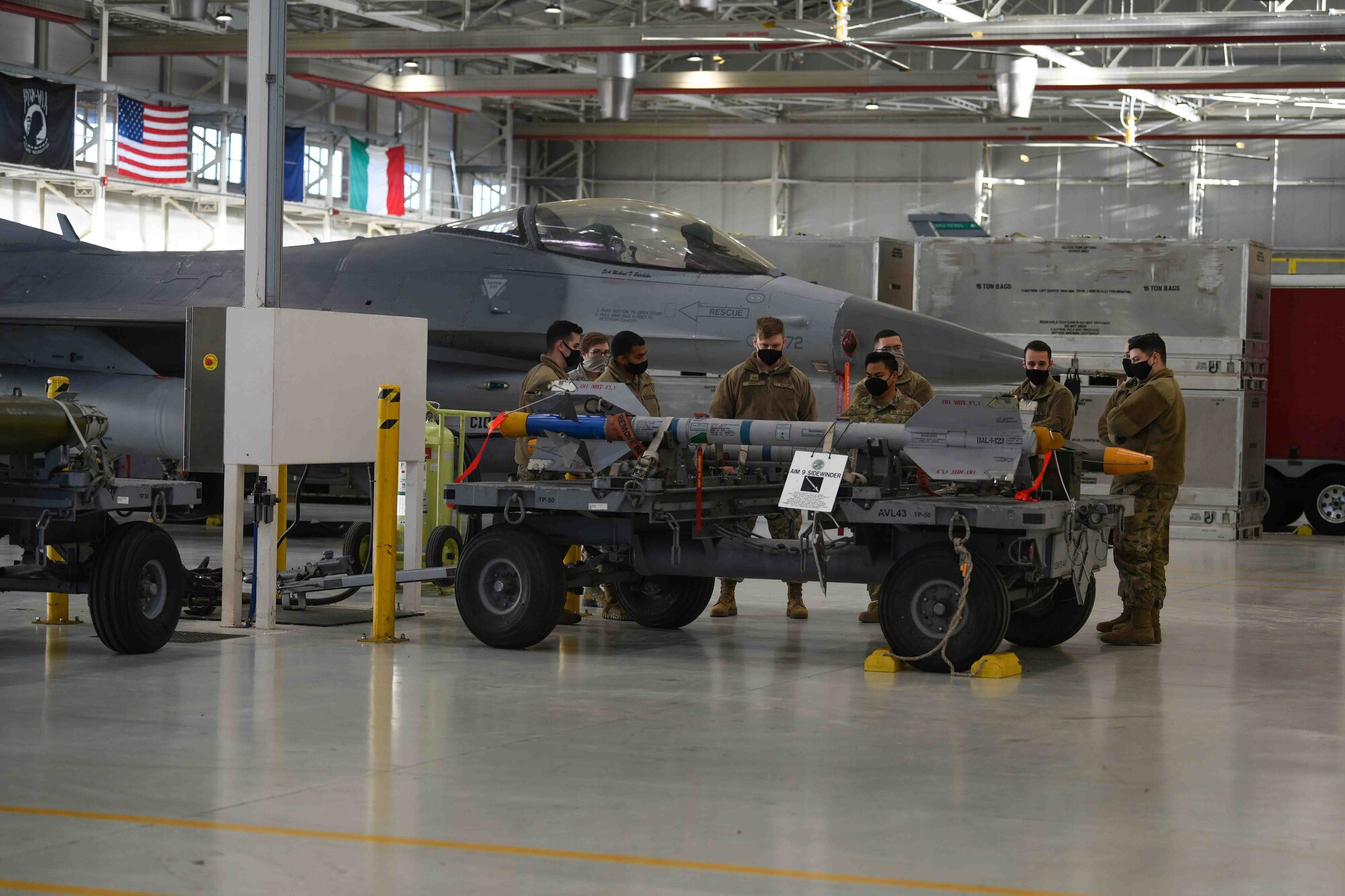 Airmen from the 31st Fighter Wing participate
in the first integrated Air Force specialty code
loading day event at Aviano Air Base, Jan. 8,
2021. Four Airmen from the 31st
Communication Squadron learned how to load
an AIM 9 Sidewinder on a U.S. Air Force F-16
Fighting Falcon. This event provided an
opportunity for Airmen from the 31st CS to step
out of their career field and participate in a
different dynamic of the 31st FW mission. (U.S.
Air Force photo by Senior Airman Ericka A.
Woolever)