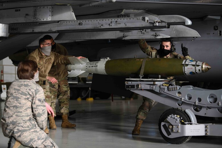 Airmen from the 31st Fighter Wing participate
in the first integrated Air Force specialty code
loading day event at Aviano Air Base, Jan. 8,
2021. Four Airmen from the 31st
Communication Squadron learned how to load
an AIM 9 Sidewinder on a U.S. Air Force F-16
Fighting Falcon. The Airmen from the 31st CS
joined the 31st Maintenance Group, weapons
standardization flight, and participated in a four
part event which included, munitions
familiarization, munition loading, and a MJ-1
bomb lift truck driving competition. (U.S. Air
Force photo by Senior Airman Ericka A.
Woolever)