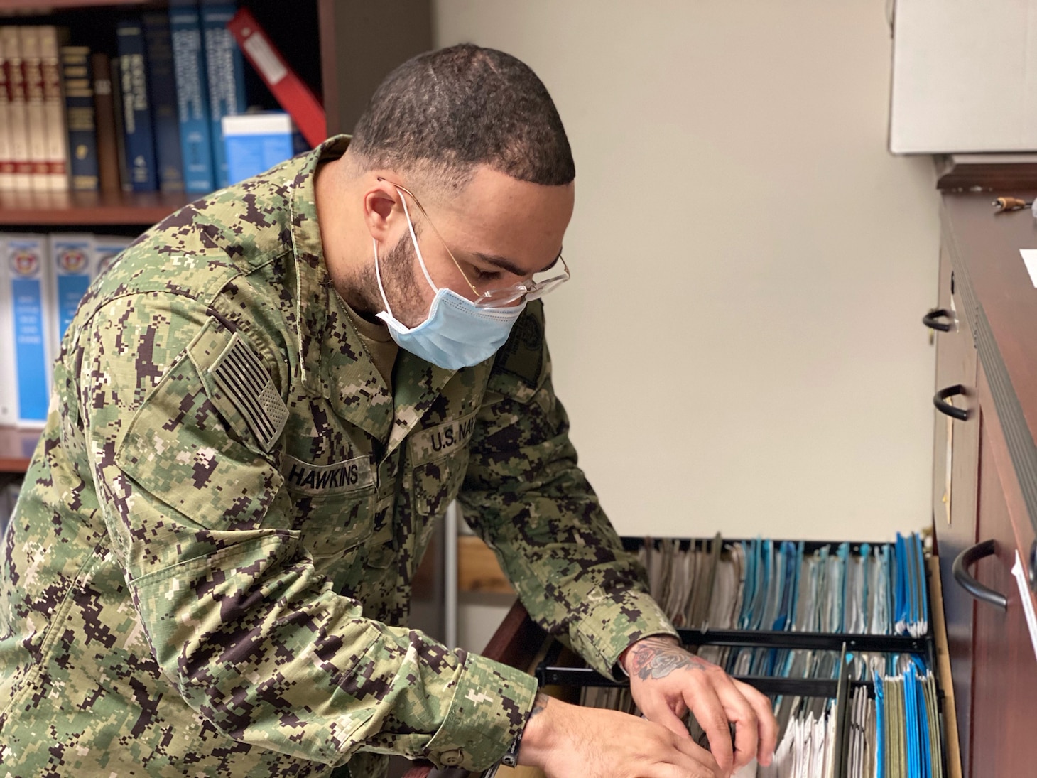 LITTLE ROCK, Arkansas (Jan. 9, 2021) - Damage Controlman 3rd Class Dante Hawkins, assigned as a Medical department representative at Navy Operational Support Center (NOSC) Little Rock, pulls a medical record while conducting physical health assessments of Selected Reservist (SELRES) Sailors during NOSC Little Rock’s first drill weekend of the year. In its effort of taking a more streamlined approach to warfighting readiness in accordance with the Chief of Navy Reserve’s recently released Fighting Instructions, NOSC Little Rock contucted tailored training, performed medical readiness examinations and immunizations, and facilitated establishing communication between SELRES Sailors and their cross-assigned in units. (U.S. Navy photo taken by Electronics Technician 1st Class Stephen Landry/Released)