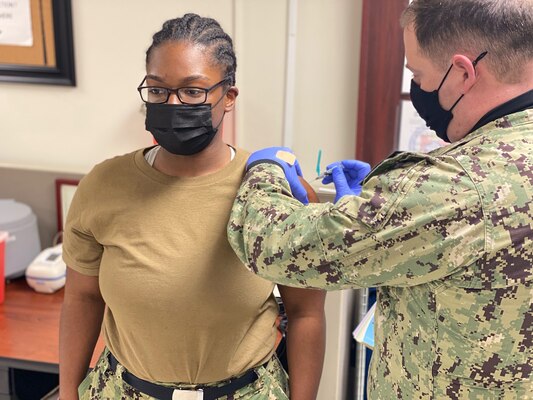 LITTLE ROCK, Arkansas (Jan. 9, 2021) - Logistics Specialist 3rd Class Jhashaira Farmer, a Selected Reservist (SELRES) Sailor, receives the influenza vaccination administered by Hospital Corpsman 2nd Class Randall Busby, a Medical department representative at Navy Operations Support Center Little Rock during the command’s first drill weekend of the year. NOSC Little Rock coordinated mission-essential training and readiness events for more than 148 SELRES Sailors during the drill weekend, which was tailored to provide a more streamlined approach to warfighting readiness in accordance with the Chief of Navy Reserve’s recently released Fighting Instructions. (U.S. Navy photo taken by Electronics Technician 1st Class Stephen Landry/Released)