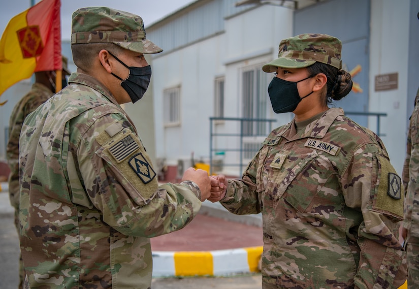 1st Sgt. Thomas Hance, left, the senior enlisted advisor for Headquarters and Headquarters Battery, 75th Field Artillery Brigade, Fort Sill, OK, congratulates Sgt. Brandy Lopez, right, an Information Technology (IT) Specialist assigned to 75th Field Artillery Brigade, on her recent promotion while deployed to the Middle East on December 28, 2020. For the past nine months, Lopez had provided countless hours of IT support and troubleshooting to every Diamond Brigade Soldier deployed to the Middle East and was selected as the only Specialist to be promoted through Battle Field Promotion within Area Support Group - Jordan. (U.S. Army photo by Sgt. Dustin D. Biven / 75th Field Artillery Brigade)