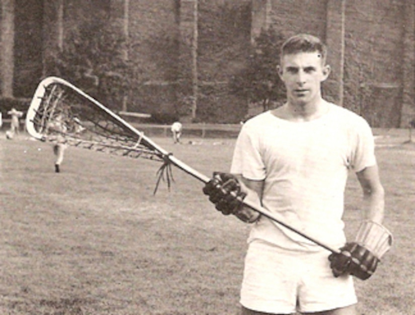 A lacrosse player poses for a photo.