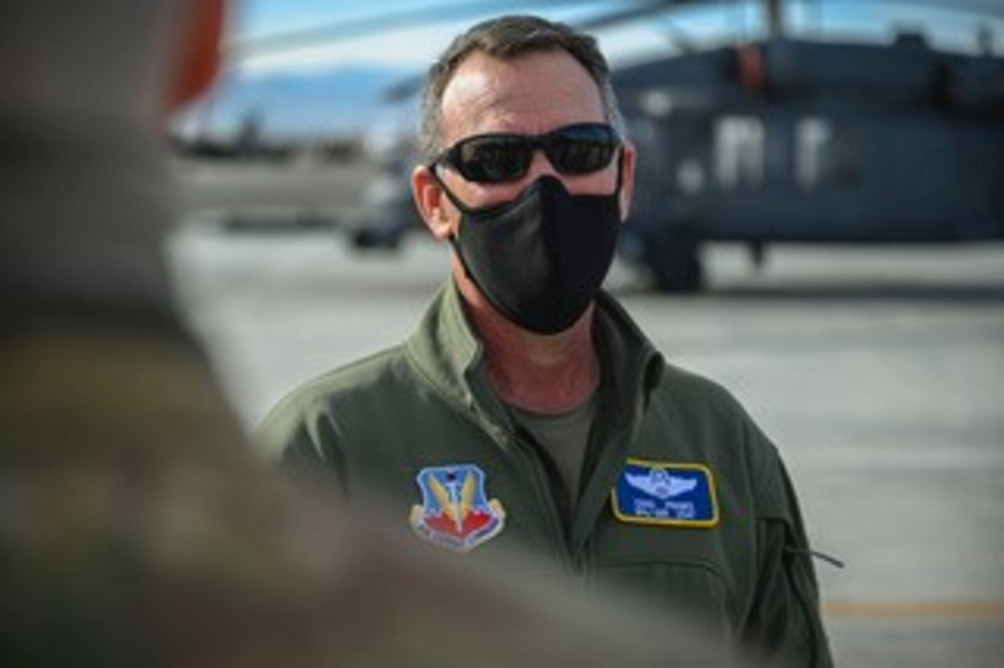 Maj. Gen. Franks stands in front of helicopter on flightline.