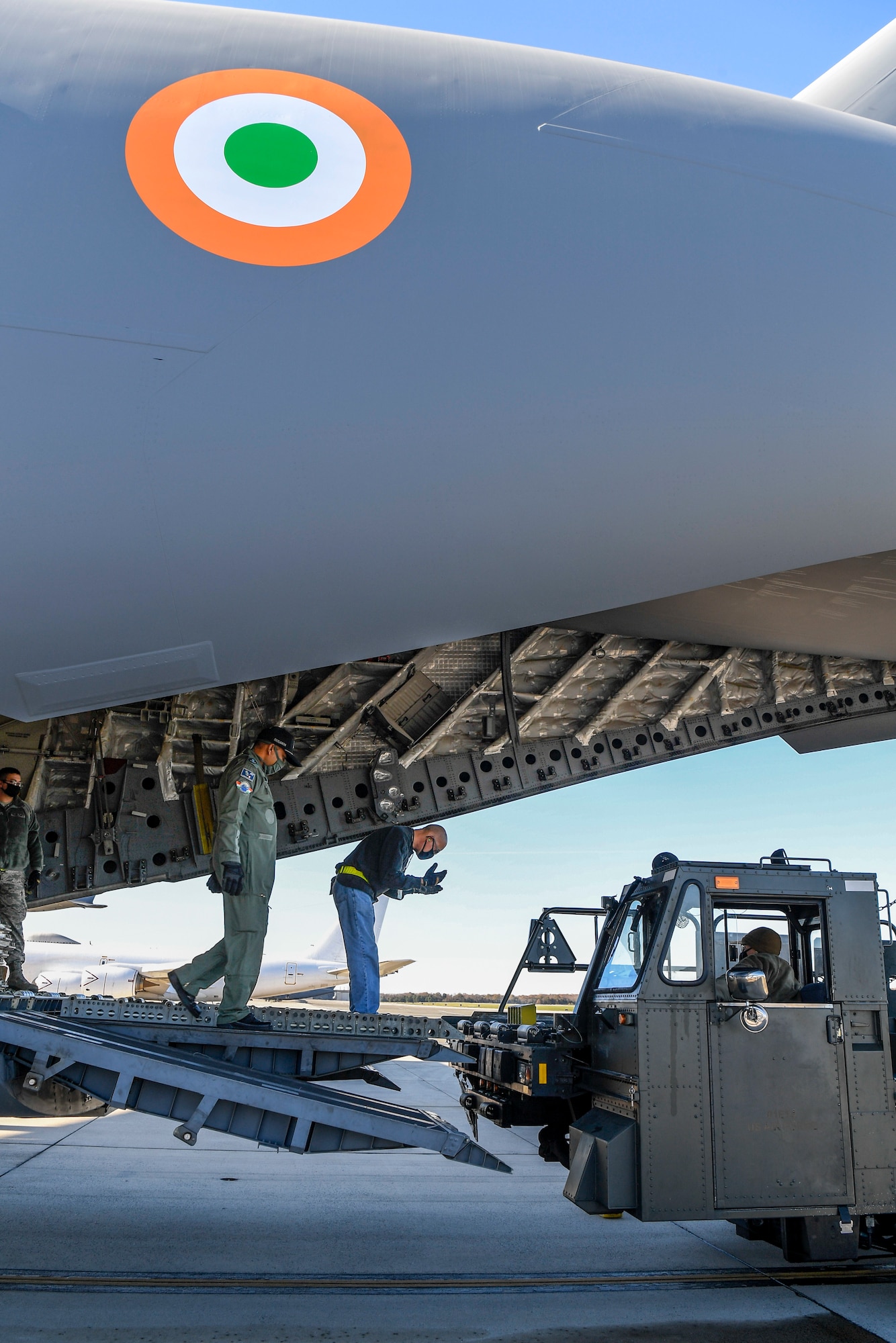 A member of the 436th Aerial Port Squadron guides a K-loader onto the ramp of an Indian air force C-17 Globemaster III Nov. 20, 2020, at Dover Air Force Base, Delaware. Dover AFB annually supports $3.5 billion worth of FMS operations due to its strategic location and 436th Aerial Port Squadron, the largest aerial port in the Department of Defense. The United States and India have shared interests in promoting global security, stability and economic prosperity. (U.S. Air Force photo by Senior Airman Christopher Quail)