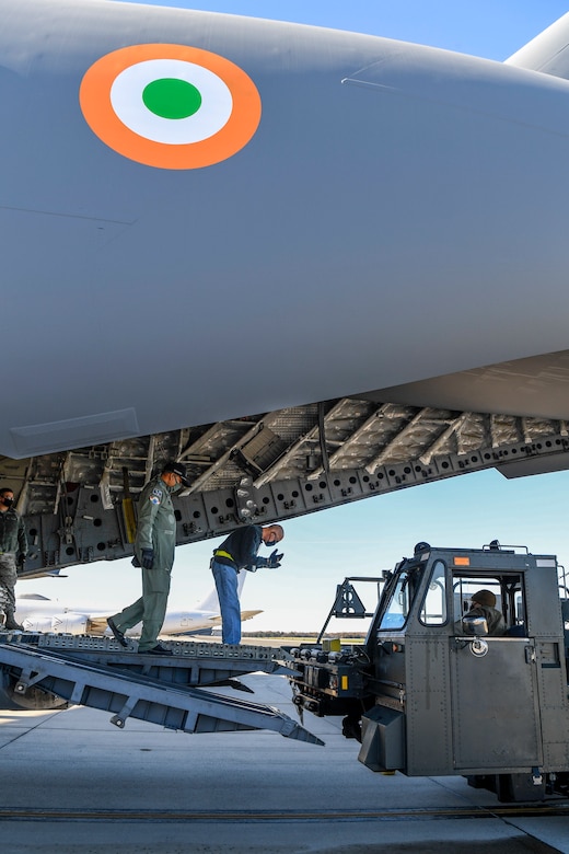 A member of the 436th Aerial Port Squadron guides a K-loader onto the ramp of an Indian air force C-17 Globemaster III Nov. 20, 2020, at Dover Air Force Base, Delaware. Dover AFB annually supports $3.5 billion worth of FMS operations due to its strategic location and 436th Aerial Port Squadron, the largest aerial port in the Department of Defense. The United States and India have shared interests in promoting global security, stability and economic prosperity. (U.S. Air Force photo by Senior Airman Christopher Quail)