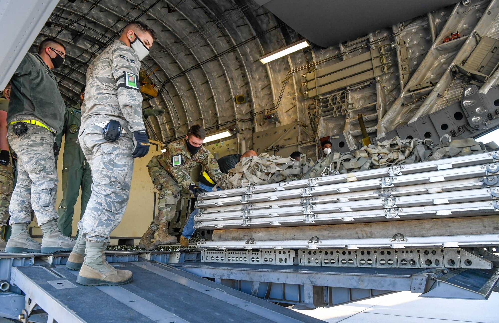Airmen from the 436th Aerial Port Squadron unload cargo from an India air force C-17 Globemaster III at Dover Air Force Base, Delaware, Nov. 20, 2020. Dover AFB annually supports $3.5 billion worth of FMS operations due to its strategic location and 436th Aerial Port Squadron, the largest aerial port in the Department of Defense. The United States and India have shared interests in promoting global security, stability and economic prosperity. (U.S. Air Force photo by Senior Airman Christopher Quail) (This image was altered for security purposes by blurring identification badges)