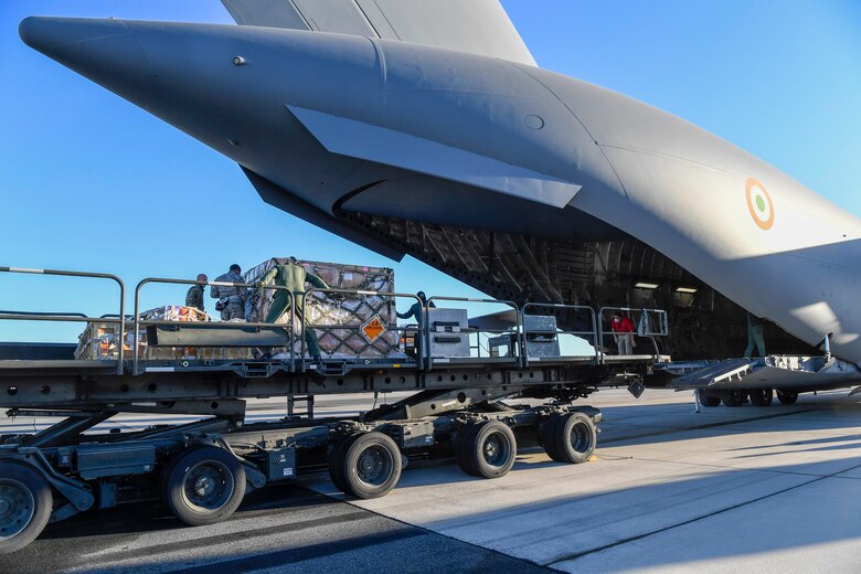 Airmen from the 436th Aerial Port Squadron prepare to load cargo onto an Indian air force C-17 Globemaster III Nov. 20, 2020, at Dover Air Force Base, Delaware. The U.S. strengthens its international partnerships through foreign military sales. Dover AFB actively supports $3.5 billion worth of FMS due to its strategic location and 436th Aerial Port Squadron, the largest aerial port in the Department of Defense. As the world’s oldest and largest democracies, the United States and India share a commitment to freedom, human rights and rule of law. (U.S. Air Force photo by Senior Airman Christopher Quail)