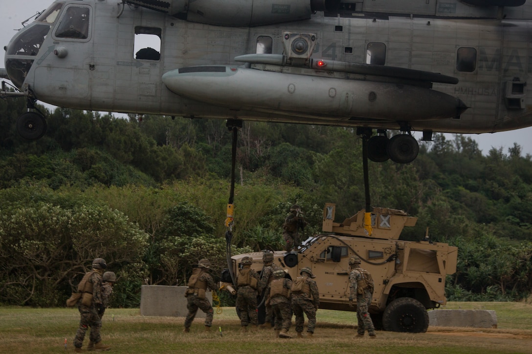 U.S. Marines with Combat Logistics Battalion 31, 31st Marine Expeditionary Unit (MEU) attach a Joint Light Tactical Vehicle Heavy Guns Carrier to a Marine CH-53E Super Stallion aircraft assigned to Marine Medium Tiltrotor Squadron 262 (Reinforced), 31st MEU, during a Helicopter Support Team (HST) training exercise as part of MEU Exercise at Kin Blue, Okinawa, Japan on Dec. 17, 2020. HST training is conducted to increase proficiency in logistics tasks and enhance the ability to execute potential contingency missions carried out by the 31st MEU. The 31st MEU, the Marine Corps only continuously forward-deployed MEU, provides a flexible and lethal force ready to perform a wide range of military operations as the premiere crisis response force in the Indo-Pacific region. (U.S. Marine Corps photo by Lance Cpl. Colton Nicks)