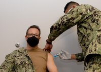 Rear Adm. Joseph A. DiGuardo Jr., commander, Navy Expeditionary Combat Command, receives the COVID-19 vaccine at Sewells Point Branch Medical Clinic in Norfolk, Va.