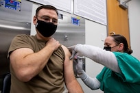 JOINT BASE LANGLEY-EUSTIS (January 11, 2021) Joint Task Force Civil Support Surgeon General Navy Capt. Dirk Warren receives the COVID-19 vaccination at McDonald Army Health Center.