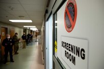 JOINT BASE LANGLEY-EUSTIS (January 11, 2021) Joint Task Force Civil Support members fill out screening paperwork while waiting to receive the COVID-19 vaccination at McDonald Army Health Center.