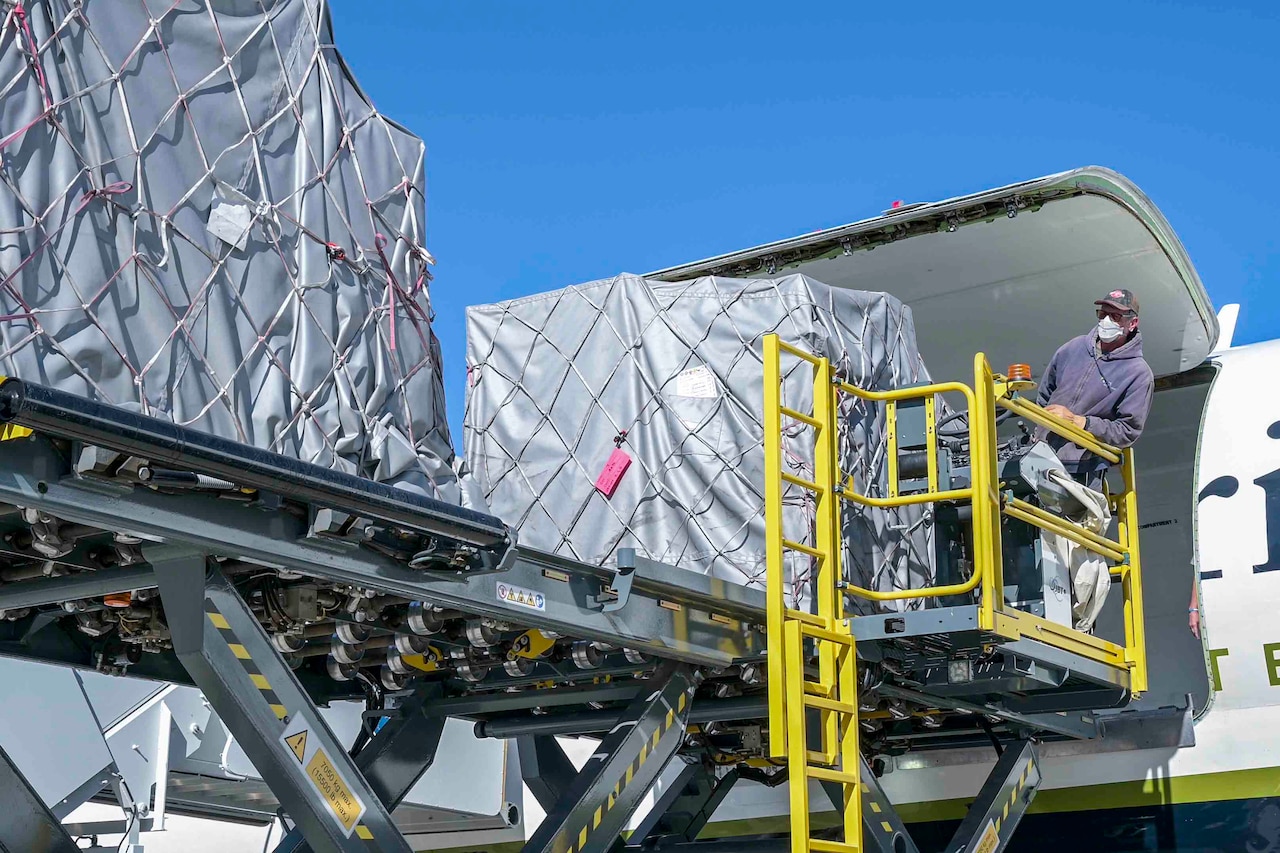 A man offloads supplies from an aircraft.