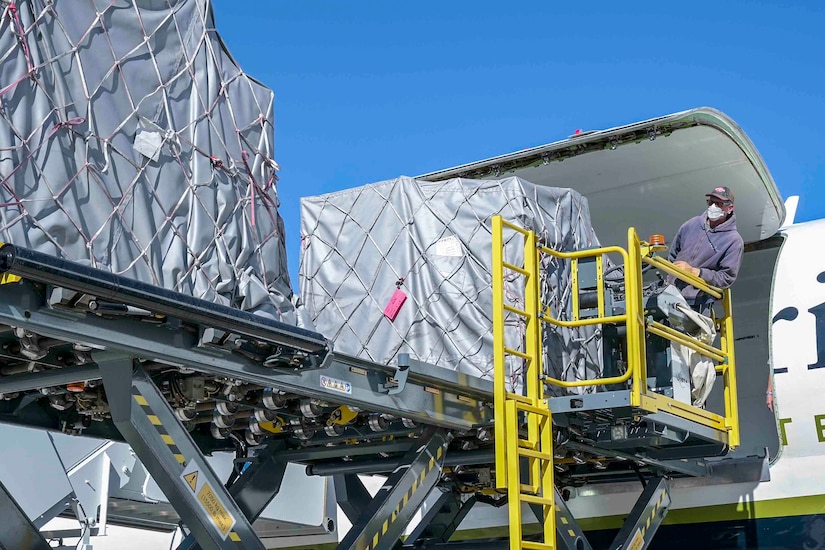 A man offloads supplies from an aircraft.