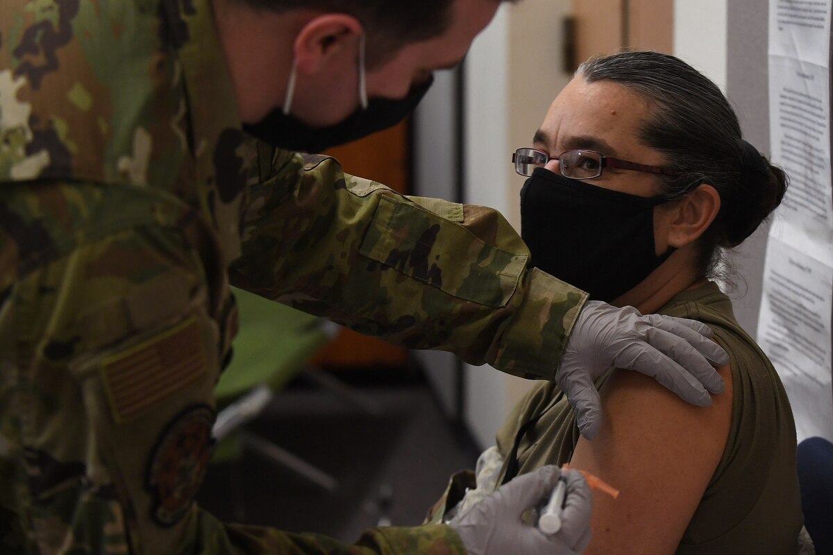 Airmen receiving a COVID-19 vaccine shot