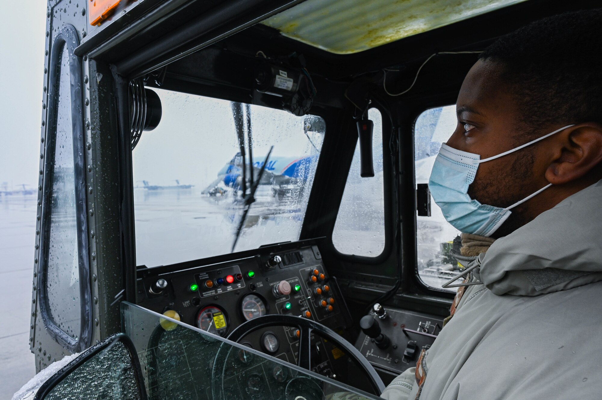An Airman drives an aircraft loader.