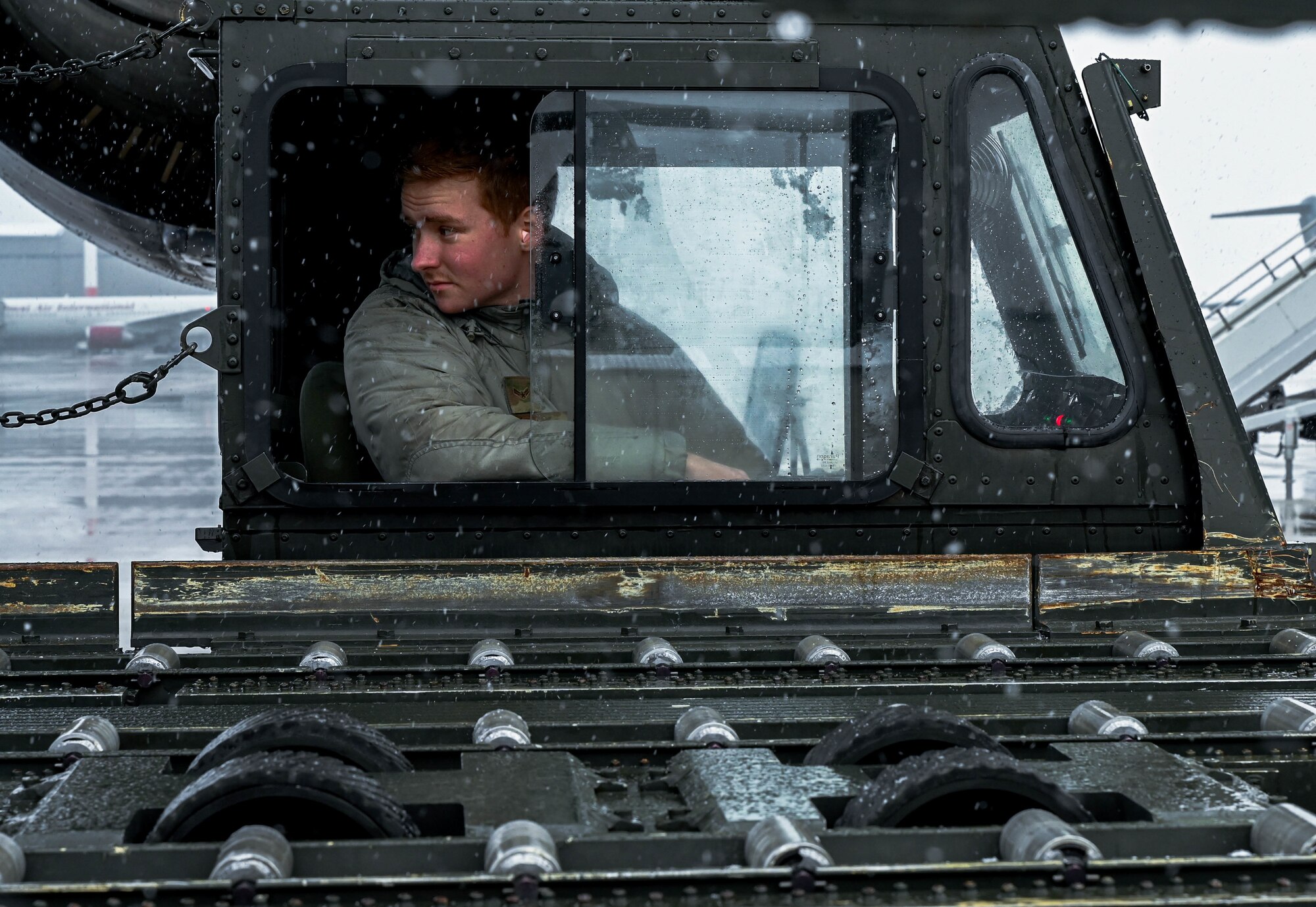 An Airman backs a vehicle away from an aircraft.