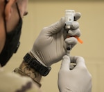 An Alabama National Guard Medical Detachment Soldier prepares a dose of COVID-19 vaccine on Jan. 7, 2021. The Alabama National Guard is administering the vaccine on a voluntary basis to members of the Guard to ensure mission readiness.