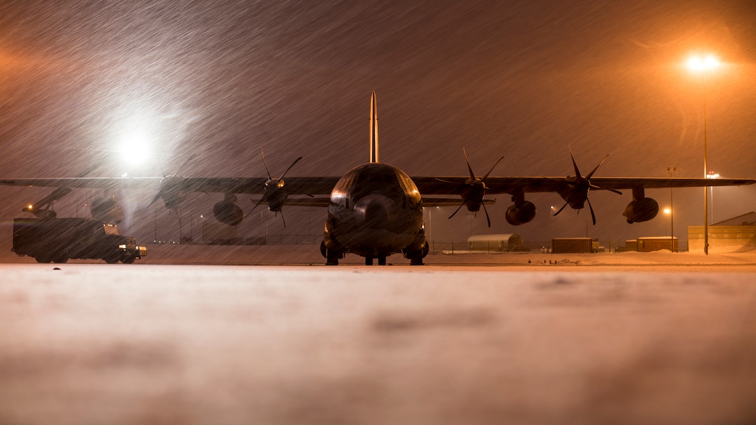 U.S. Marines de-ice a Marine KC-130J Super Hercules aircraft before takeoff from Joint Base Elmendorf-Richardson, Alaska, Dec. 9.