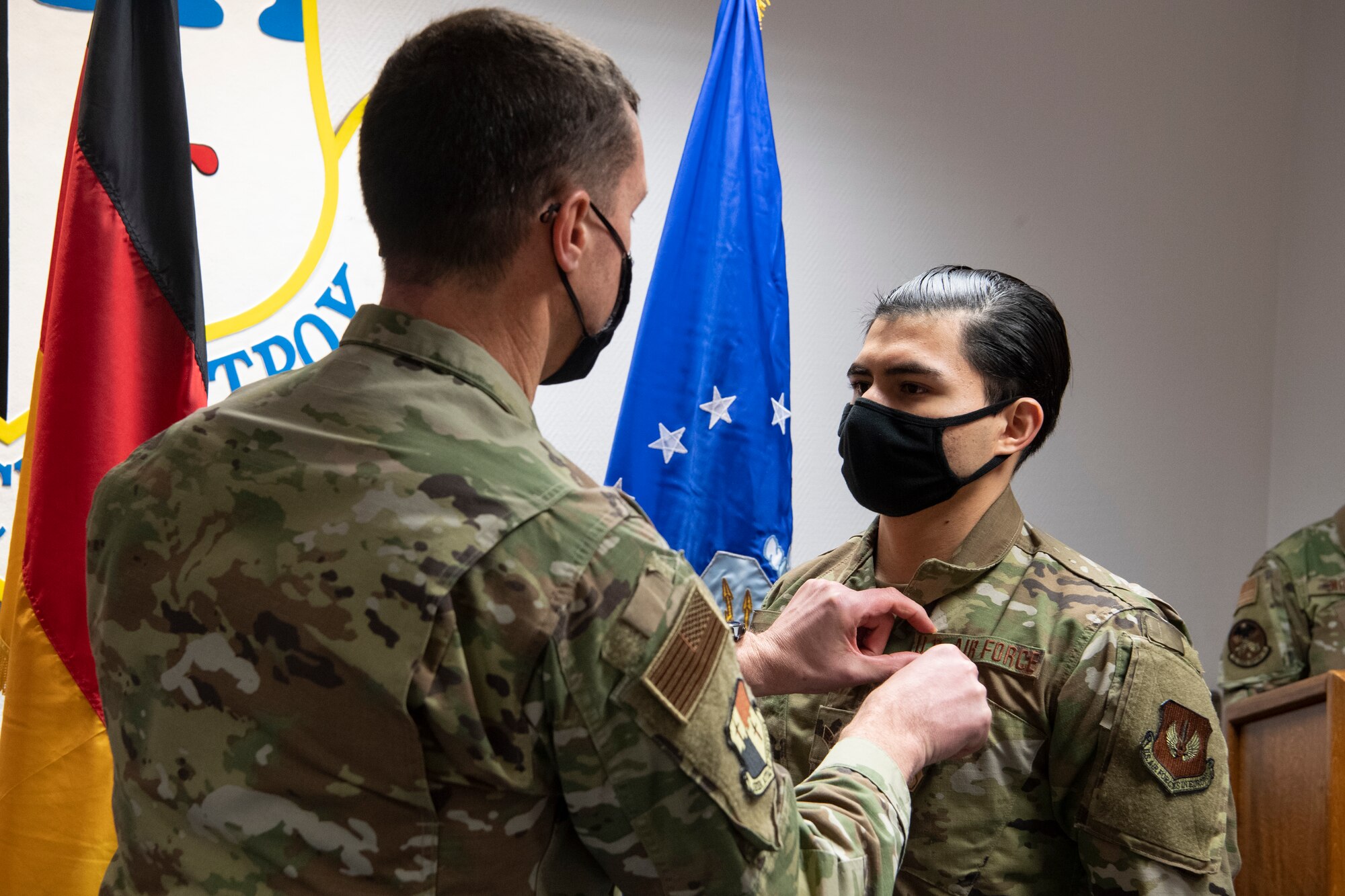 U.S. Air Force Col. David Epperson, 52nd Fighter Wing commander, presents an Air Force Commendation Medal to U.S. Air Force Senior Airman Ezekiel Lopez, 52nd Force Support Squadron fitness center journeyman.