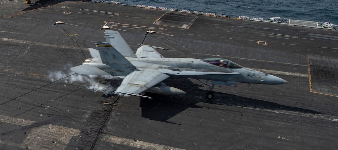 NORTH ARABIAN SEA (Jan. 9, 2021) An F/A-18C Hornet, from the “Death Rattlers” of Marine Fighter Attack Squadron (VMFA) 323, makes an arrested landing on the flight deck of the aircraft carrier USS Nimitz (CVN 68). Nimitz, the flagship of Nimitz Carrier Strike Group, is deployed to the U.S. 5th Fleet area of operations to ensure maritime stability and security in the Central Region, connecting the Mediterranean and Pacific through the Western Indian Ocean and three critical chokepoints to the free flow of global commerce. (U.S. Navy photo by Mass Communication Specialist Seaman Joseph Calabrese)