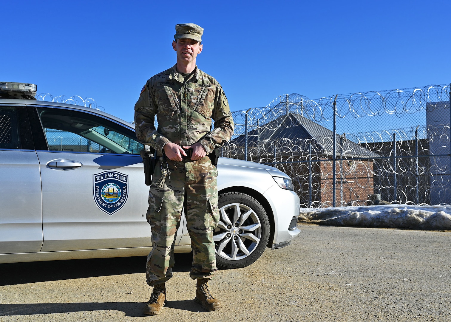 New Hampshire National Guard 1st Lt. James Lawrence, a military police officer with the 237th Military Company, with his issued patrol car on the perimeter of the N.H. State Prison for Men in Concord, N.H., on Jan. 10, 2021. Lawrence is one of 20 Guard members filling in at the prison due to a shortage of corrections officers caused by COVID-19.
